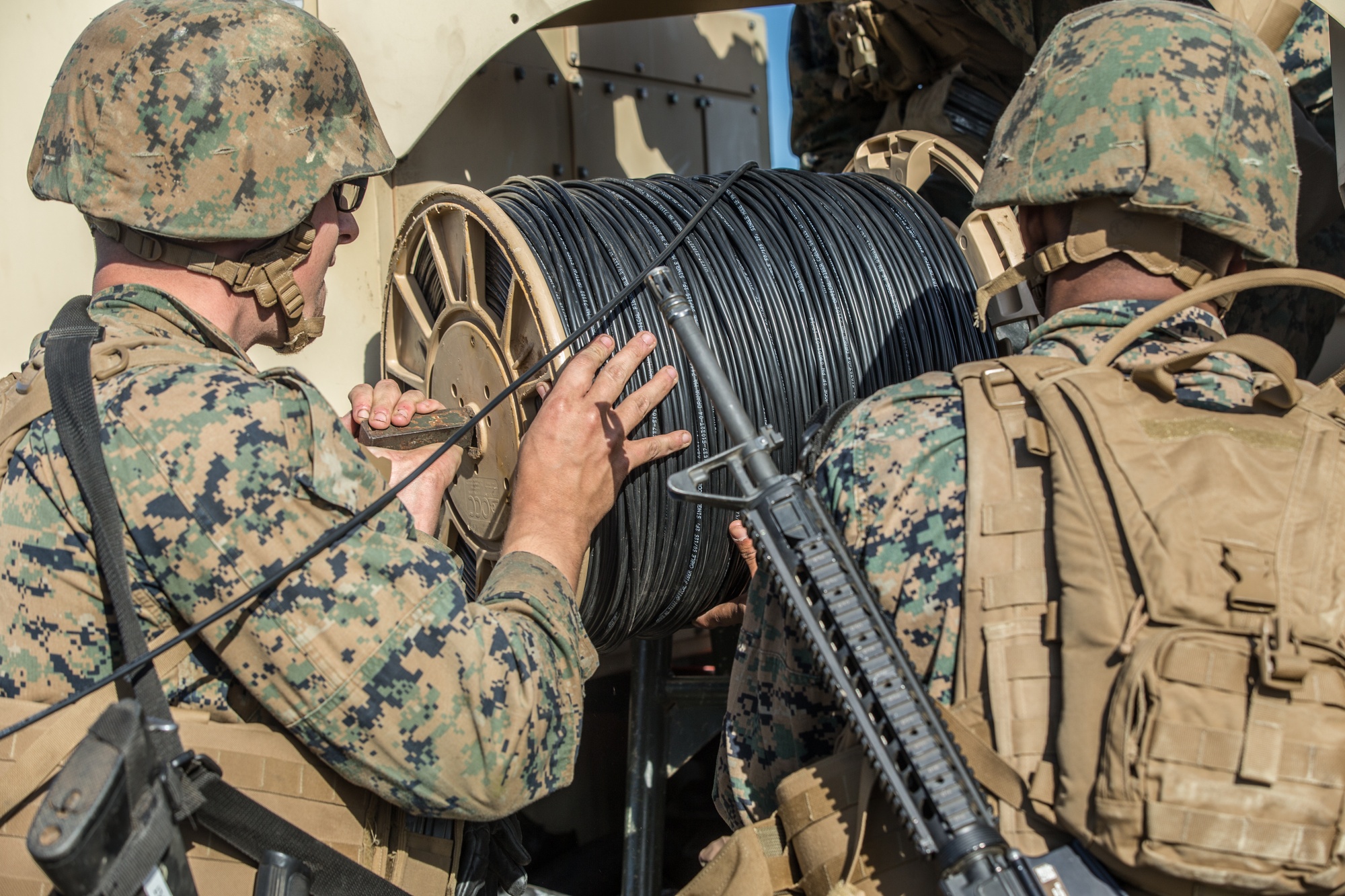 U.S. Marines retrieving tactical fiber during a field exercise